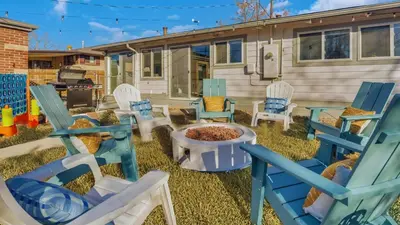a yard with chairs and a fire pit and a caravan at 15min to Denver - AirHockey - Arcade - Minigolf - Sleeps10 in Westminster