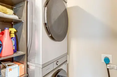 a refrigerator with a washer and dryer in a room at Beautiful Home with Bonus Room and Prime Location! in Brighton