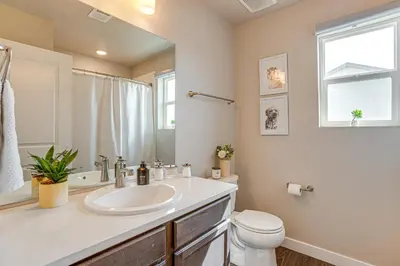 a bathroom with a sink and a toilet and a window at Beautiful Home with Bonus Room and Prime Location! in Brighton