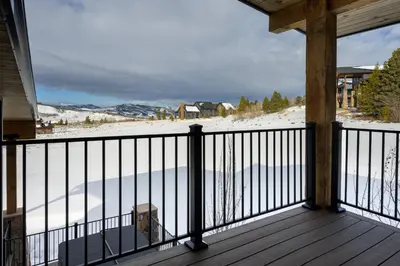 a balcony with a view of a snow covered field at Lone Eagle 855 in Granby