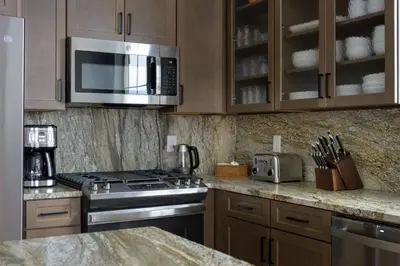 a kitchen with a stove and a microwave at Timber Court in Granby