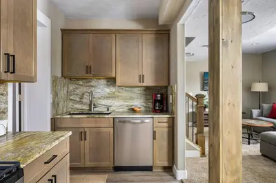 a kitchen with wooden cabinets and a sink at Timber Court in Granby