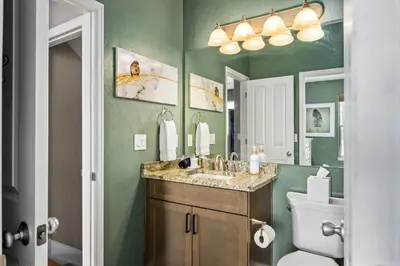 a bathroom with a sink and a toilet and a mirror at Timber Court in Granby
