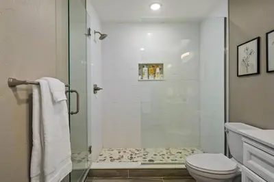 a bathroom with a glass shower with a toilet at Timber Court in Granby