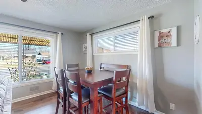 a dining room with a table and chairs and a window at Spacious Family Home with King Beds and Big Yard in Denver