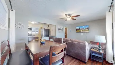 a living room with a table and a couch at Spacious Family Home with King Beds and Big Yard in Denver