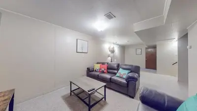 a living room with a couch and a table at Spacious Family Home with King Beds and Big Yard in Denver