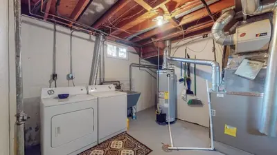 a laundry room with a washer and dryer at Spacious Family Home with King Beds and Big Yard in Denver