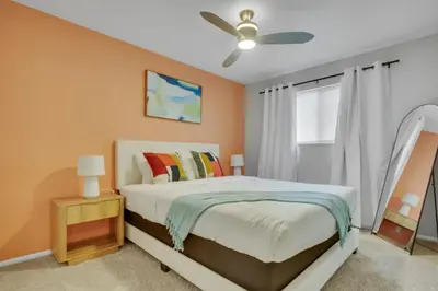 a bedroom with a bed and a ceiling fan at Chic Family Retreat with Game Room backyard with fire pit and minutes to Downtown! in Arvada