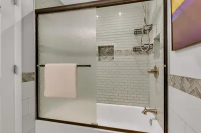a bathroom with a shower with a glass door at Chic Family Retreat with Game Room backyard with fire pit and minutes to Downtown! in Arvada