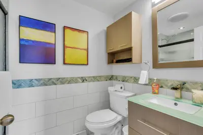 a bathroom with a toilet and a sink at Chic Family Retreat with Game Room backyard with fire pit and minutes to Downtown! in Arvada