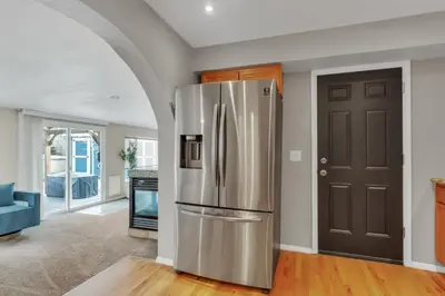 a kitchen with a stainless steel refrigerator at Chic Family Retreat with Game Room backyard with fire pit and minutes to Downtown! in Arvada