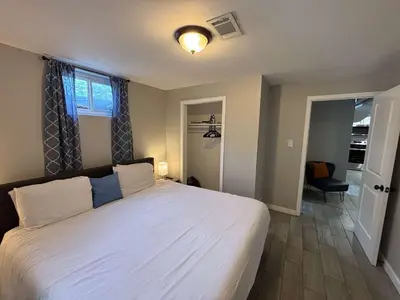 a bedroom with a large white bed and a window at Gorgeous 2-King-Bed Lower Unit in Denver in Denver