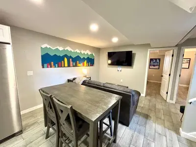 a living room with a table and a couch at Gorgeous 2-King-Bed Lower Unit in Denver in Denver
