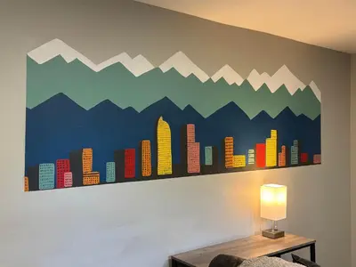 a mural of mountains and buildings on a wall at Gorgeous 2-King-Bed Lower Unit in Denver in Denver