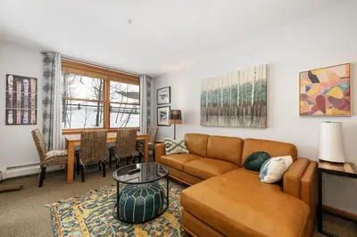 a living room with a couch and a table at Premium Unit 1305 - Zephyr Mountain Lodge condo in Winter Park