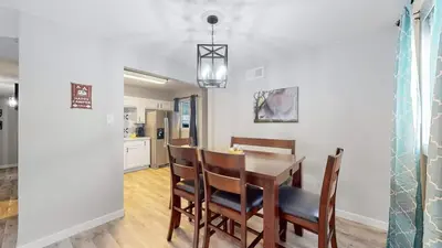 a kitchen and dining room with a table and chairs at Two bedroom family home near Anschutz Medical in Aurora