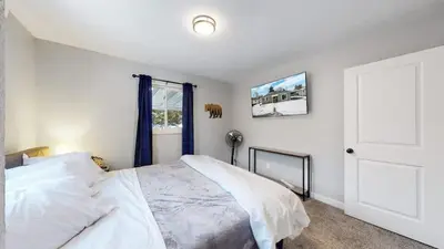 a bedroom with a white bed and a window at Two bedroom family home near Anschutz Medical in Aurora