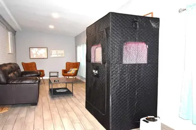 a living room with a couch and a table at Bright basement unit with large yard and sunroom in Denver