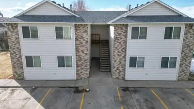 a house with two white garage doors at Convenient two bedroom near DIA in Brighton