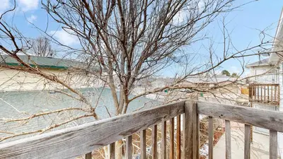 a view of the beach from a wooden fence at Convenient two bedroom near DIA in Brighton