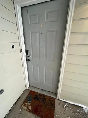 a door to a garage with a bike painted on it at Convenient two bedroom near DIA in Brighton