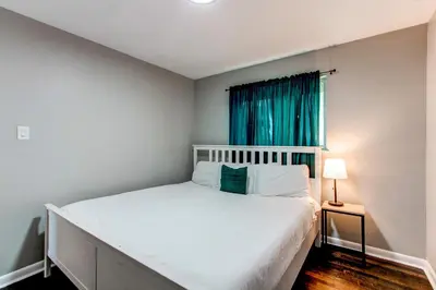 a bedroom with a white bed and a window at Spacious family home in Littleton with fenced yard in Littleton