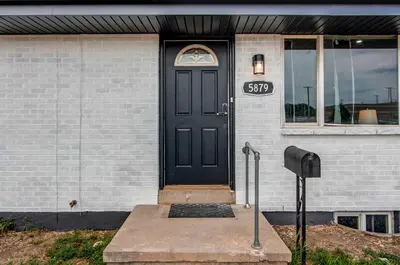 a black door on a house with a sign on it at Spacious family home in Littleton with fenced yard in Littleton