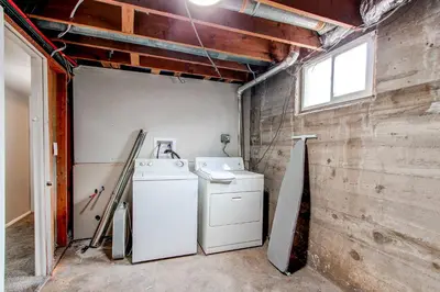 a laundry room with a washing machine and a window at Spacious family home in Littleton with fenced yard in Littleton