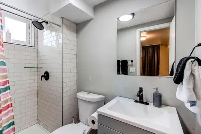 a bathroom with a sink and a toilet and a shower at Spacious family home in Littleton with fenced yard in Littleton