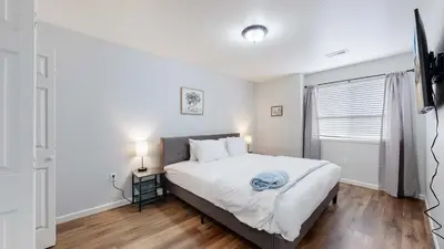 a bedroom with a large white bed and a window at Spacious two bedroom apartment near DIA in Brighton