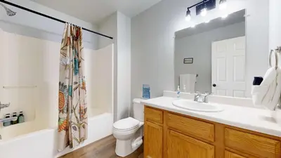 a bathroom with a sink and a toilet and a mirror at Spacious two bedroom apartment near DIA in Brighton