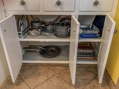 a cabinet filled with dishes and pots and pans at Charming two bedroom family home in coveted neighborhood in Denver