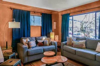 a living room with two couches and a table at Charming two bedroom family home in coveted neighborhood in Denver