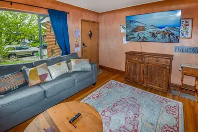 a living room with a couch and a table at Charming two bedroom family home in coveted neighborhood in Denver