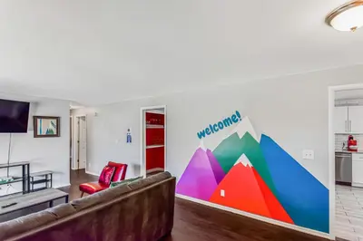 a living room with a couch and a colorful wall at Huge family home in Centennial with five bedrooms large yard and plenty of parking in Centennial