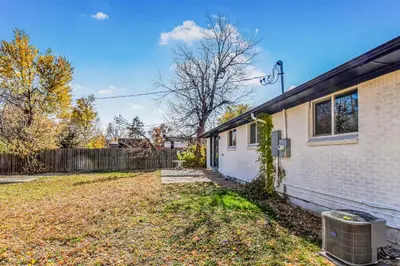 an empty yard next to a house at Huge family home in Centennial with five bedrooms large yard and plenty of parking in Centennial