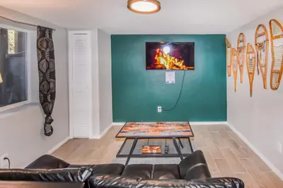 a living room with a couch and a table at Cozy two bedroom basement unit near light rail in Denver