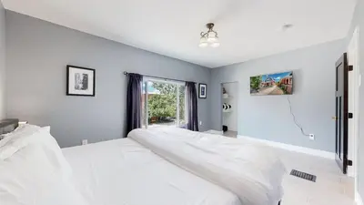 a bedroom with a large white bed and a window at Spooky Victorian Family house with four bedrooms central to downtown in Denver