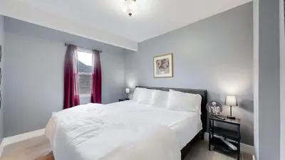 a bedroom with a large white bed and a window at Spooky Victorian Family house with four bedrooms central to downtown in Denver
