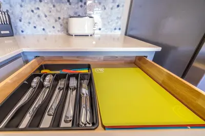 a tray with utensils on a counter in a kitchen at Near Airport, 3BR, Stock Tank Pool, Mini-Golf, Game Rm in Commerce City