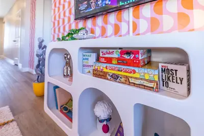 a shelf in a toy dog house with snacks at Near Airport, 3BR, Stock Tank Pool, Mini-Golf, Game Rm in Commerce City