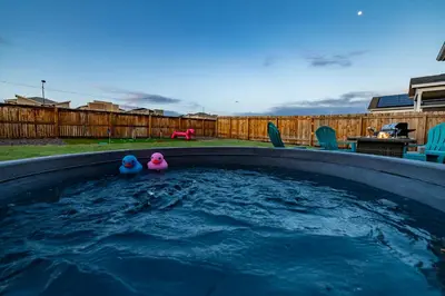 two rubber ducks sitting in a pool of water at Near Airport, 3BR, Stock Tank Pool, Mini-Golf, Game Rm in Commerce City