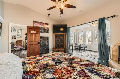 a bedroom with a bed and a ceiling fan at Heron Pond in Broomfield