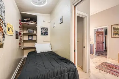 a small bedroom with a bed in a room at Heron Pond in Broomfield