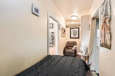 a bedroom with a bed and a chair in a room at Heron Pond in Broomfield