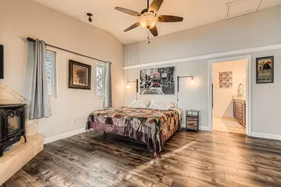 a bedroom with a bed and a ceiling fan at Heron Pond in Broomfield
