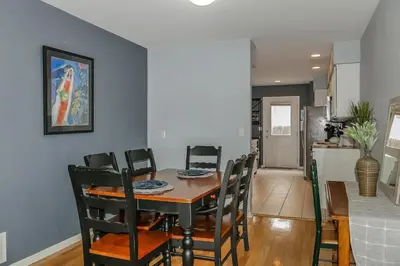 a dining room and kitchen with a table and chairs at Charming Family Home with Cozy Retreat in Denver