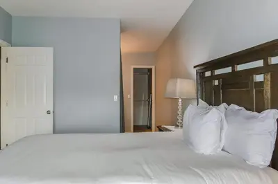 a bedroom with a large white bed with white pillows at Charming Family Home with Cozy Retreat in Denver