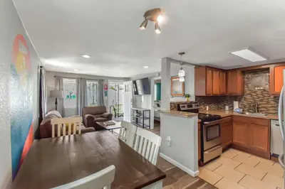a kitchen and living room with a table and a dining room at Dog Friendly and Family Sized Home in Denver Perfect for Your Furry Friend in Denver
